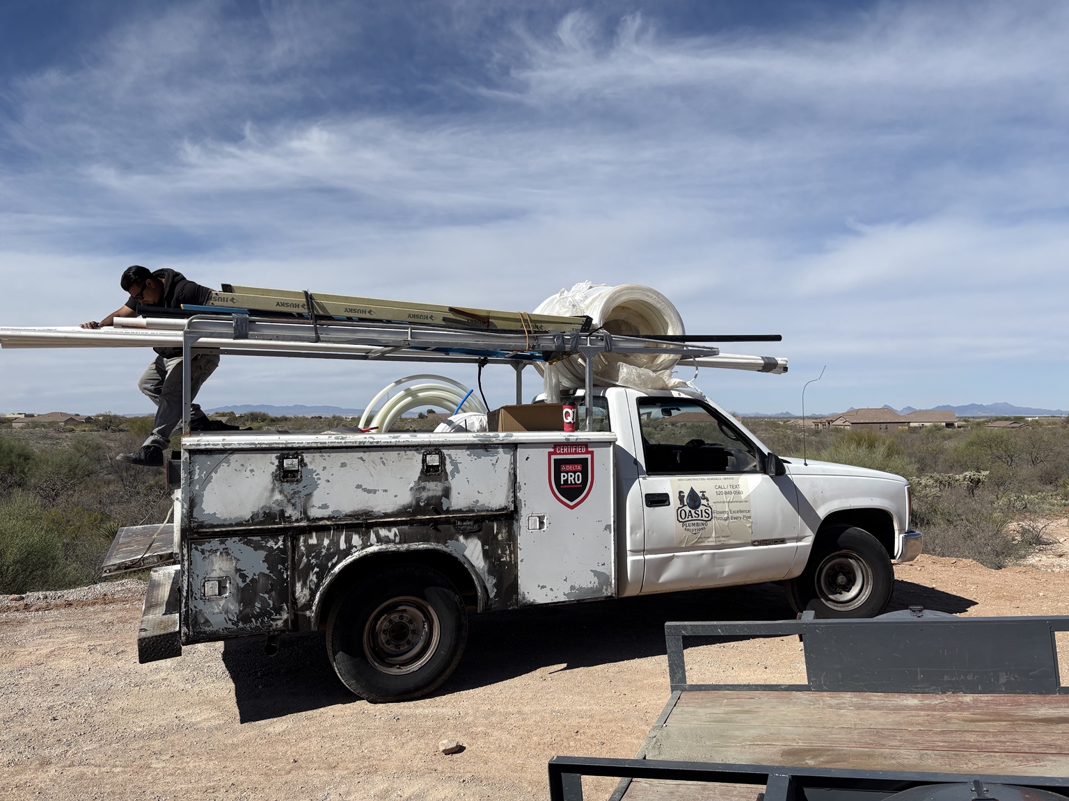 Oasis Plumbing Solutions service truck working at a Southern Arizona property