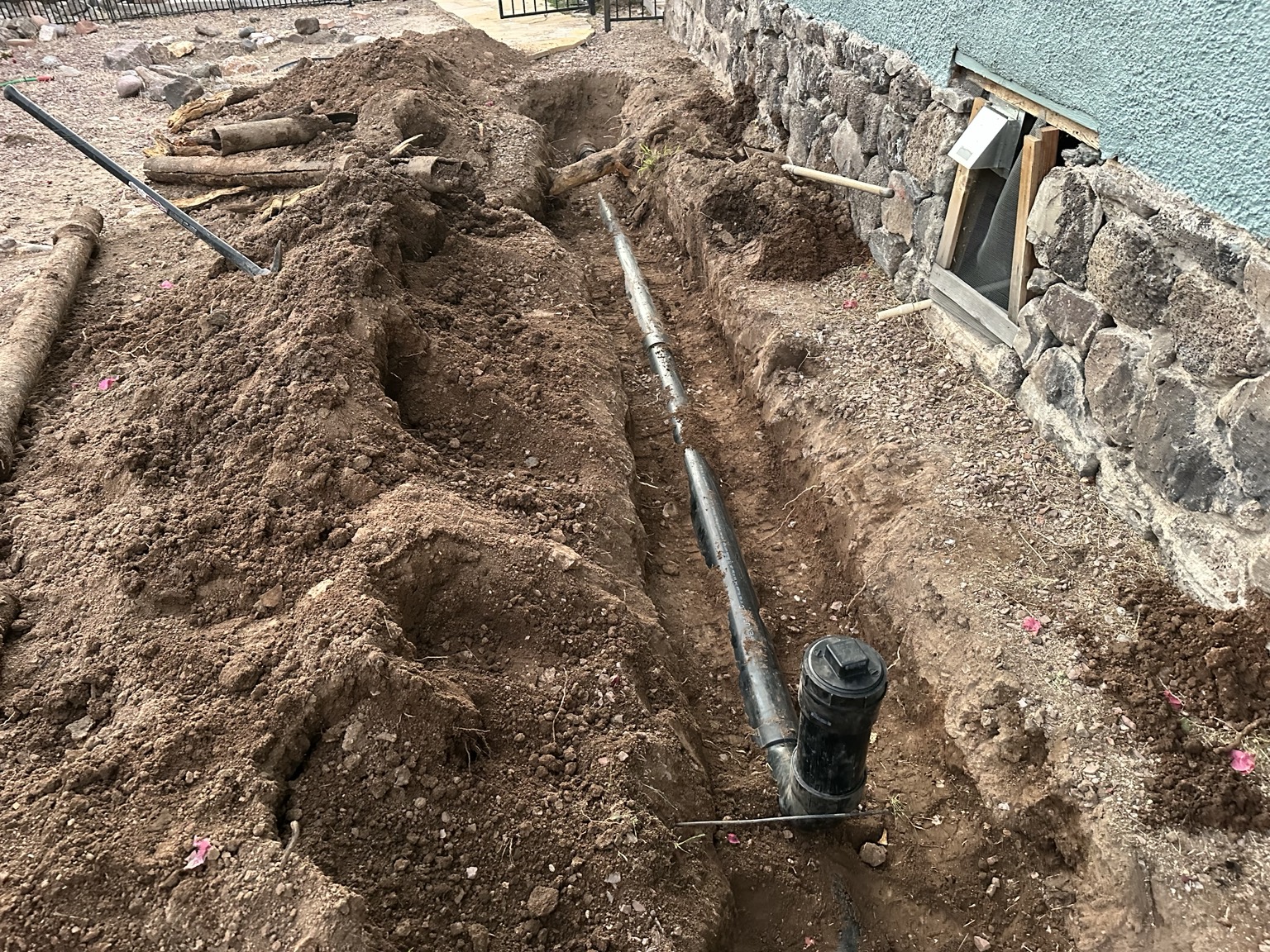 Main sewer line exposed for inspection and replacement at a Tucson property